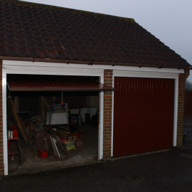 The detached, street-facing, double-door garage where Samuel's body was stored for a period of time. Whoever moved him would have had to do so in full view of the street.