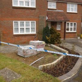 Close-up of building works to the front of the house, with bricks on palettes. These were ordered by Sami and delivered to the house by truck on 18 June 2009. The black cable would have provided power to lights and a water feature in the area under construction (where the pallets of bricks are).